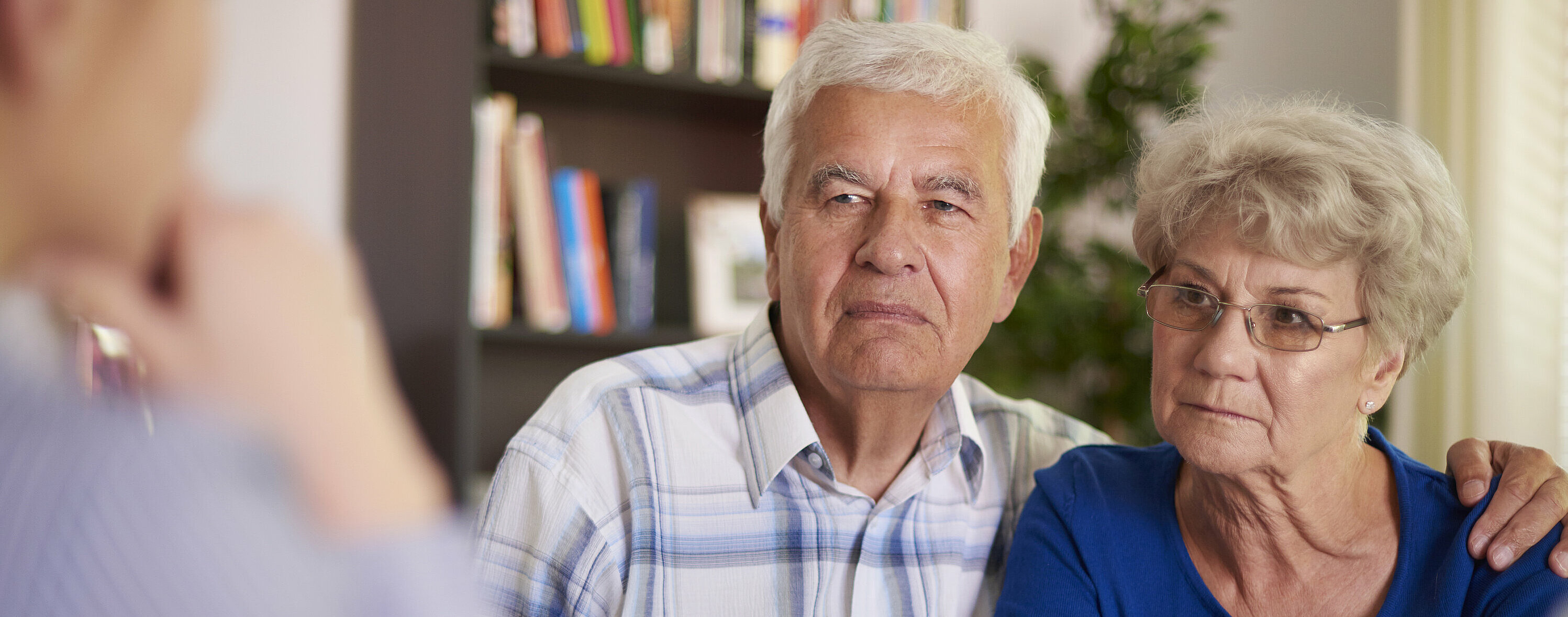 Serious senior couple sitting in the office