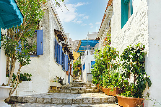 Narrow street in old town of Marmaris, Turkey . Beautiful scenic old ancient white houses with flowers.