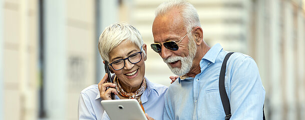 Older Handsome Businessman is Walking in the City Streets with his Female Business Partner Older Handsome Businessman is Walking in the City Streets with his Female Business Partner