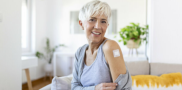 Adhesive bandage on arm after injection vaccine or medicine,ADHESIVE BANDAGES PLASTER - Medical Equipment,Soft focus Adhesive bandage on a female brachium after covid-19 vaccination