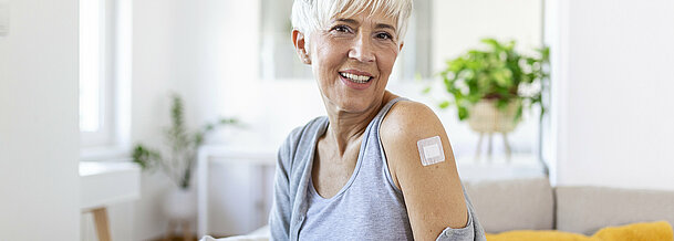 Adhesive bandage on arm after injection vaccine or medicine,ADHESIVE BANDAGES PLASTER - Medical Equipment,Soft focus Adhesive bandage on a female brachium after covid-19 vaccination