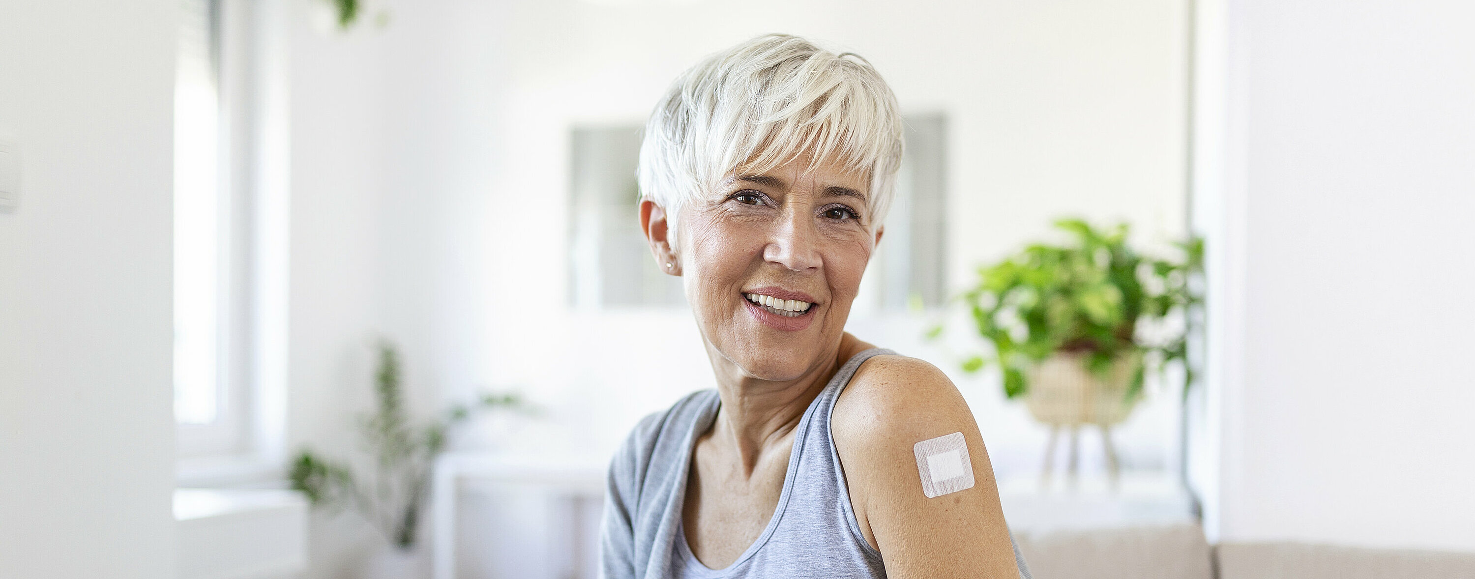 Adhesive bandage on arm after injection vaccine or medicine,ADHESIVE BANDAGES PLASTER - Medical Equipment,Soft focus Adhesive bandage on a female brachium after covid-19 vaccination
