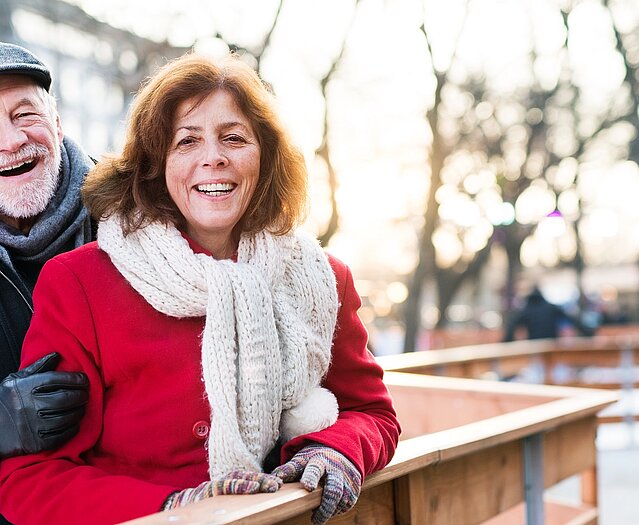 Senior couple on a walk in a city in winter.
