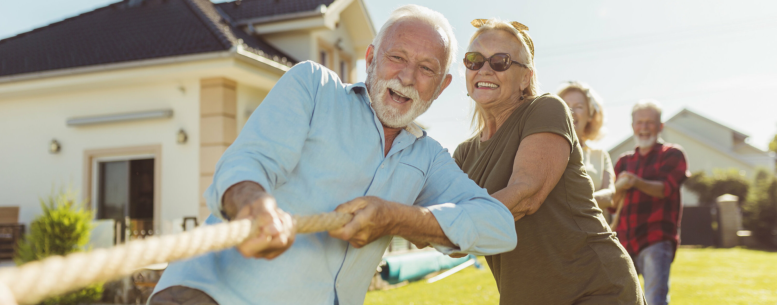 Senior people participating in rope pulling competition