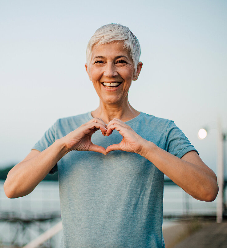 Active senior woman making a heart with her hands Active senior woman making a heart with her hands