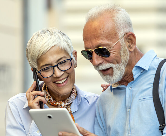 Older Handsome Businessman is Walking in the City Streets with his Female Business Partner